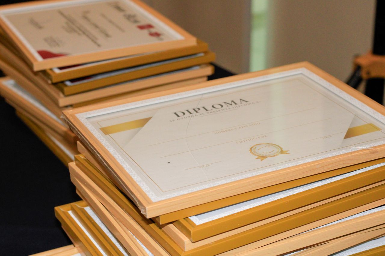 about-us A stack of elegant framed diplomas prepared for an academic ceremony.