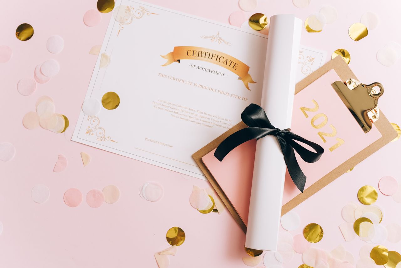 Crafting Captivating Headlines: Your awesome post title goes here A rolled-up diploma with a certificate of achievement surrounded by confetti, perfect for graduation themes.